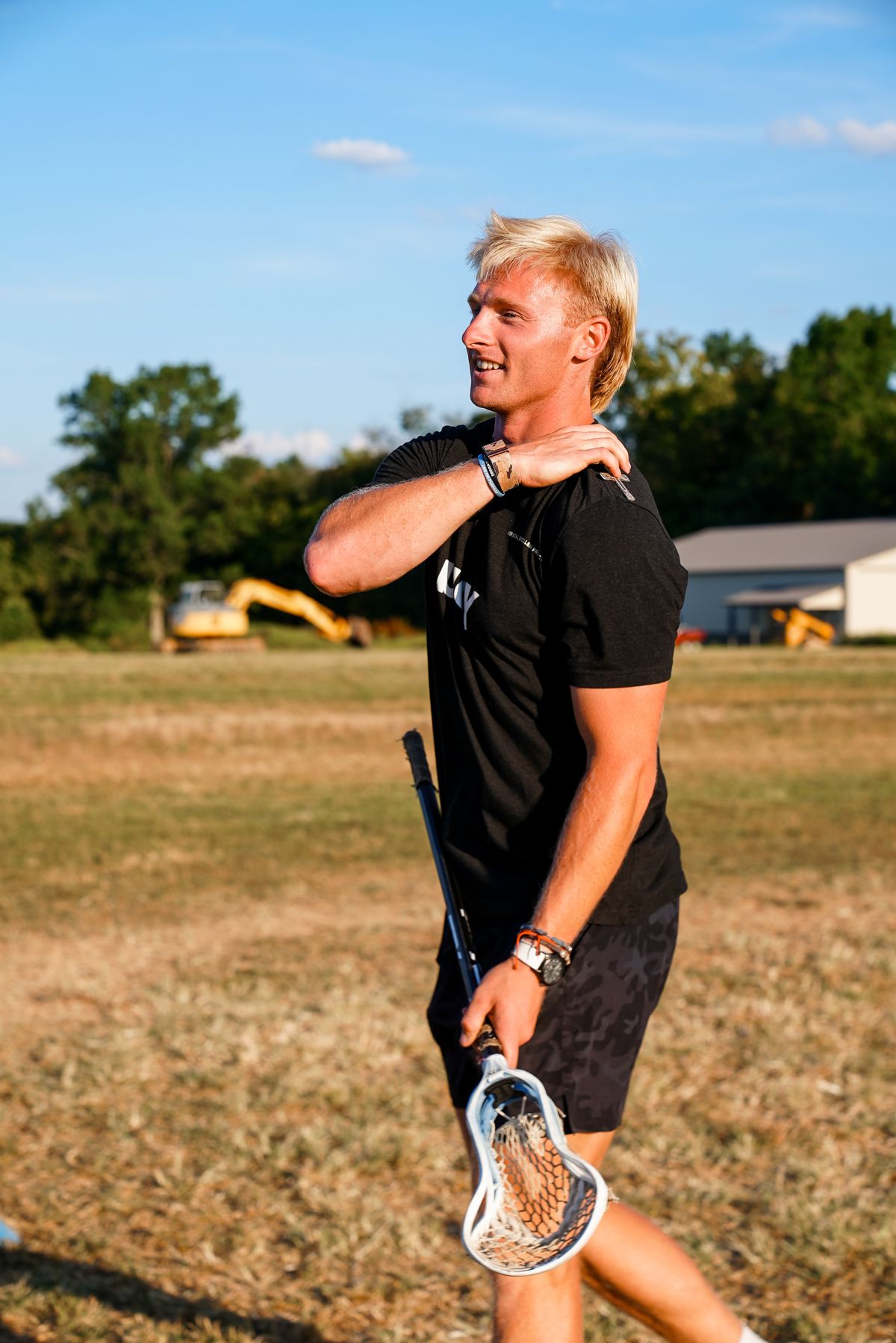 Henry Schertzinger on the field at The Barn, stick in hand.